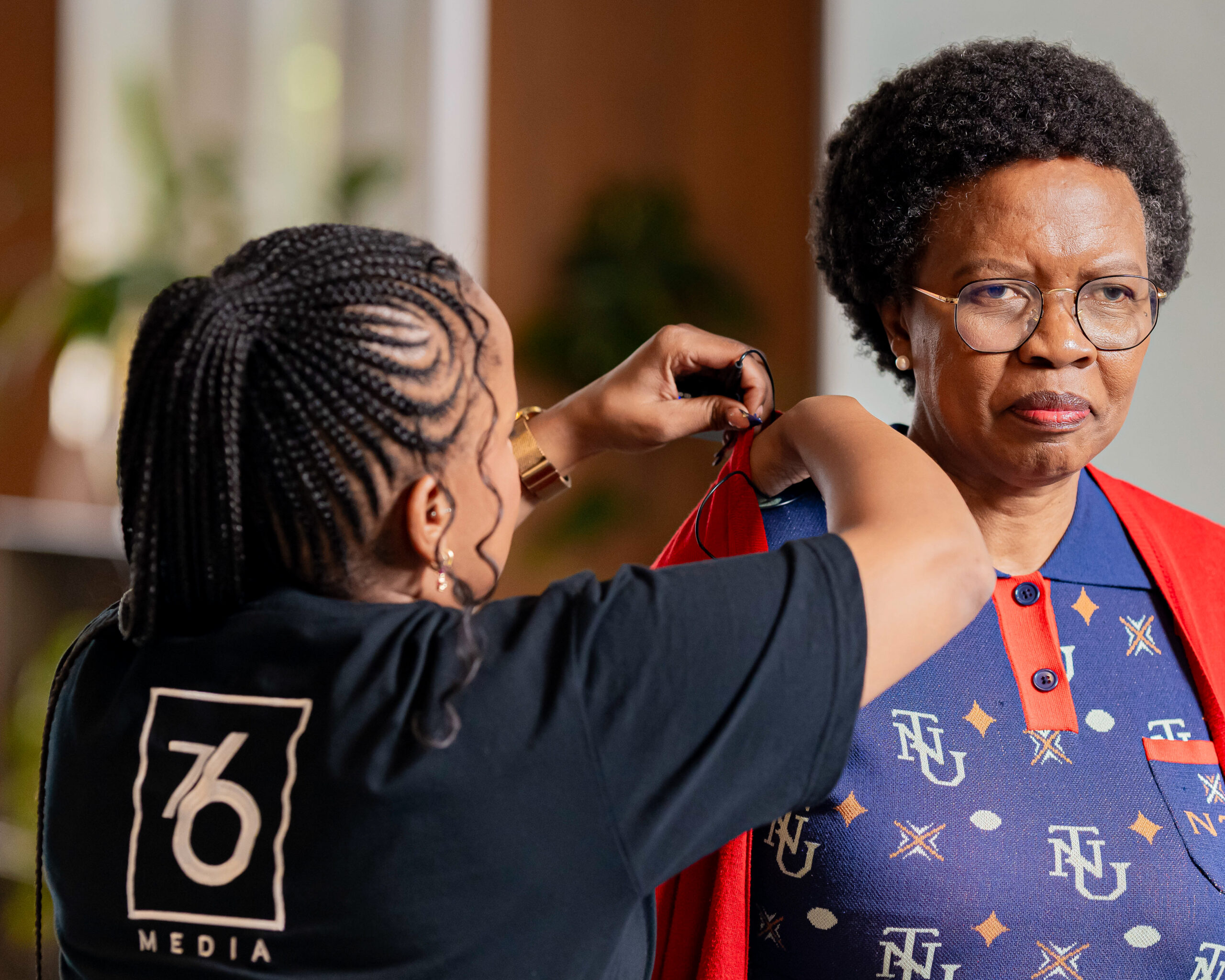 76 Media production team preparing a speaker backstage at the 15th Zanele Mbeki International Women's Day Dialogue